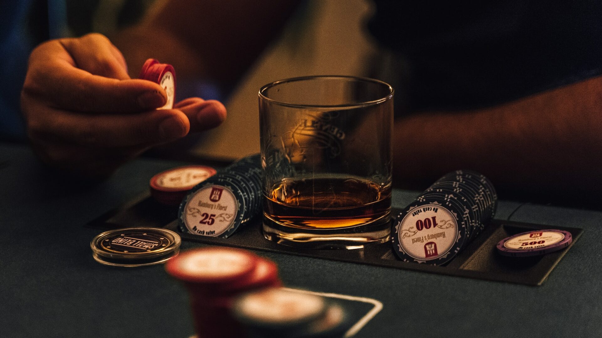 A man playing poker in low light