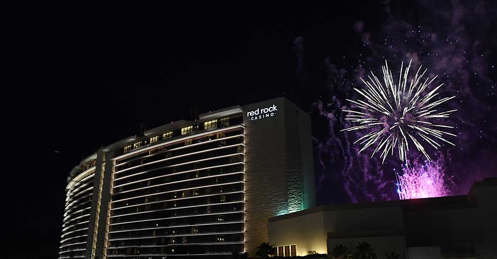 red rock casino with a firework in teh background