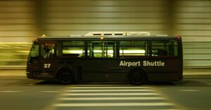 An airport shuttle driving through a tunnel