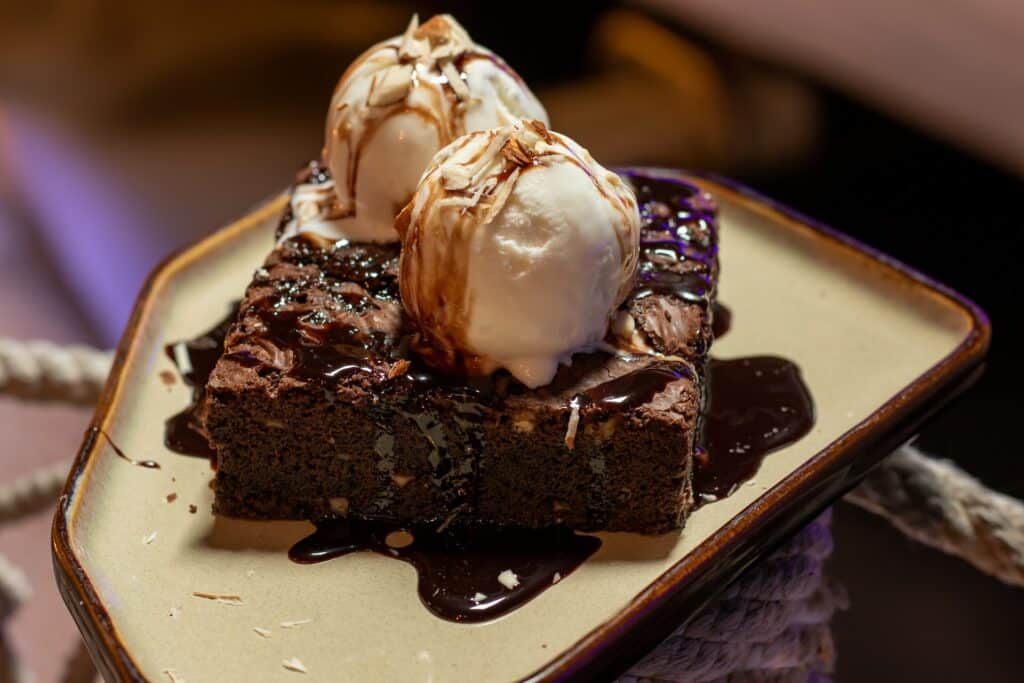 Brownies on a plate with ice cream on top