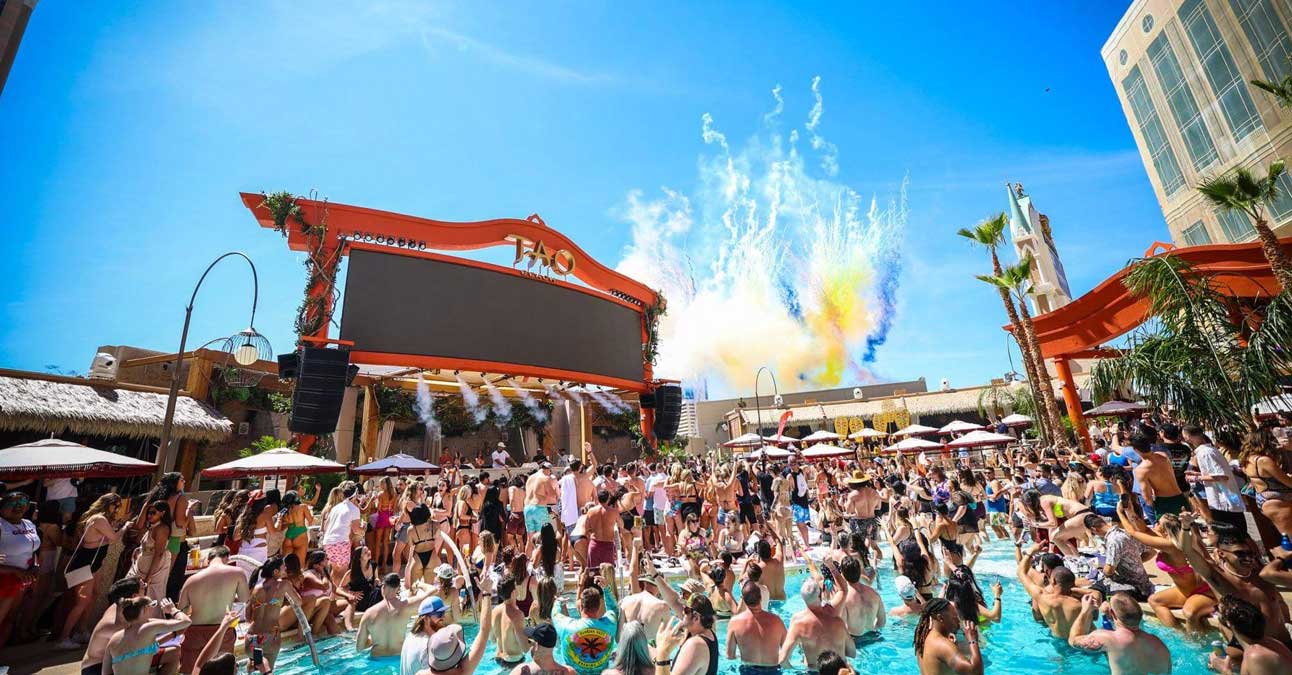 Big crowd of young people drining in a Vegas swimming pool