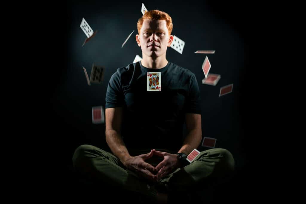 A man with cards falling around him
