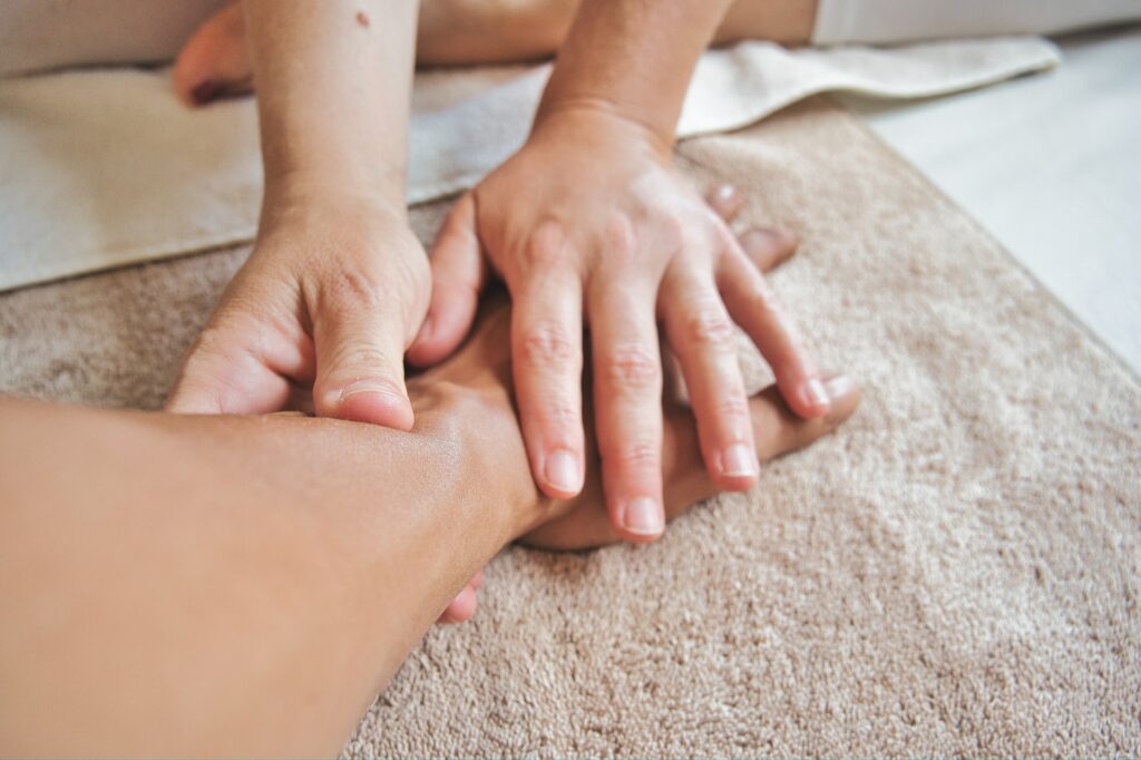 A person giving a hand massage