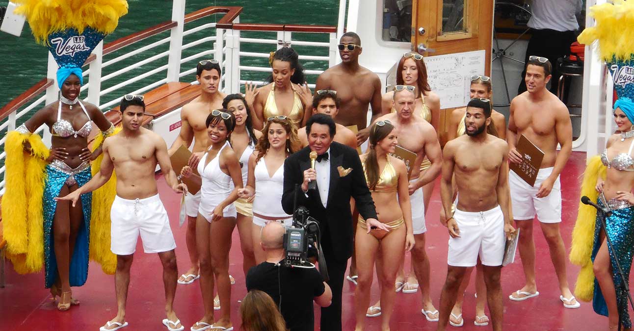 Wayne Newton on a boat with backing dancers