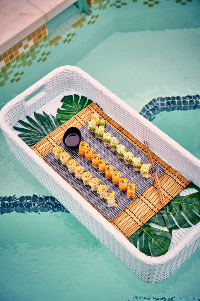 sushi floating in the pool at TAO Beach Club