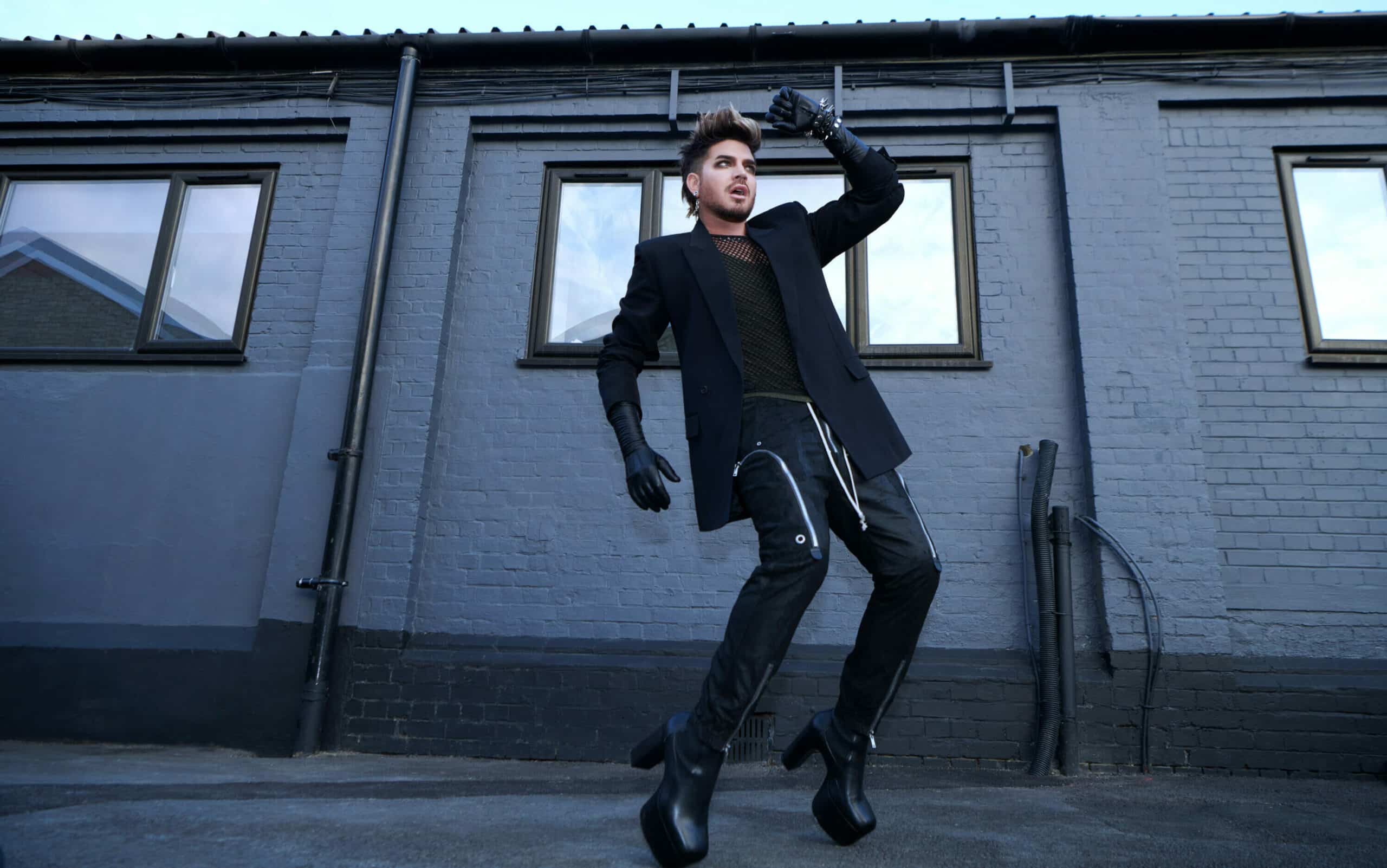Adam Lambert jumping in a pose