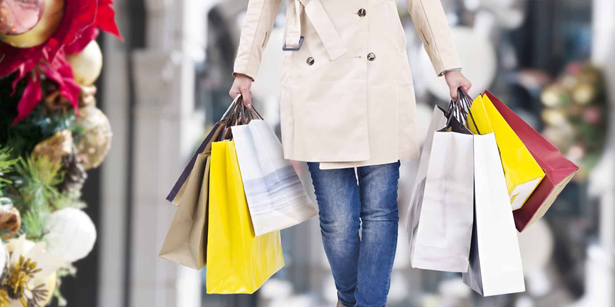 Woman walking with shopping bags doing Christmas shopping.