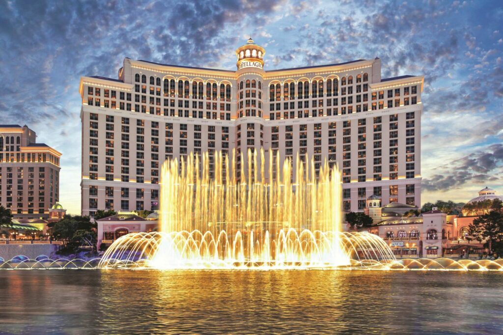 The famous Bellagio fountains lit up at dusk.
