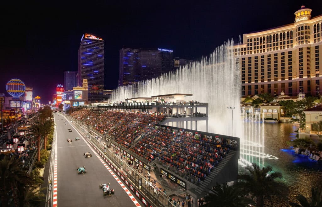 Formula 1 cars racing past the Bellagio grandstand at night