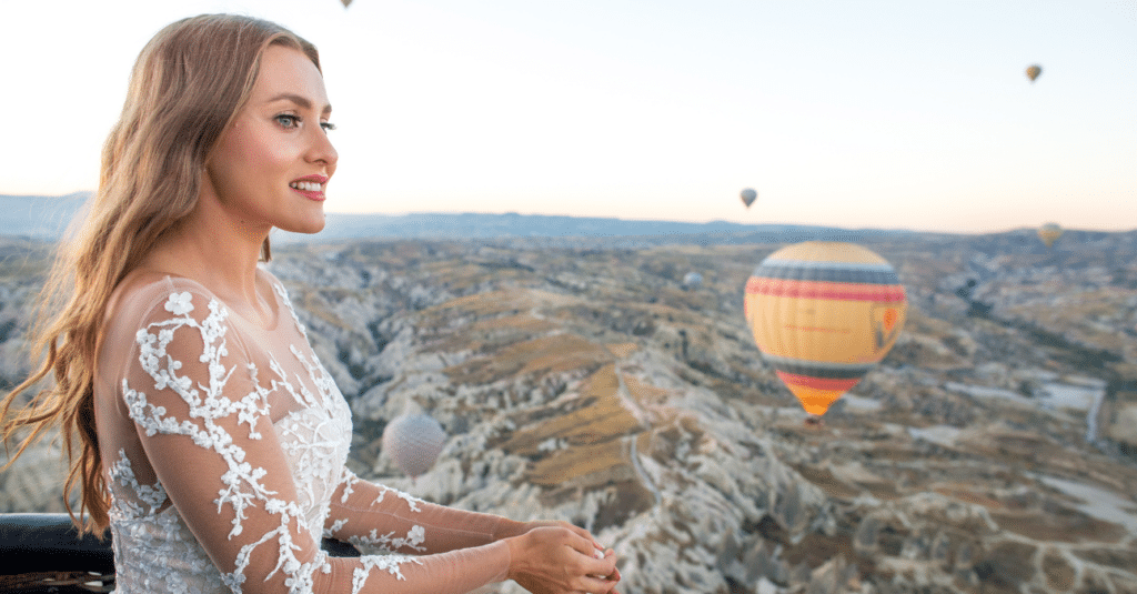A Las Vegas bride looking out over air balloons in the sky