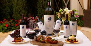 Multiple bottles of Opus One wine with various foods.